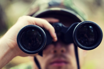 close up of soldier or hunter with binocular