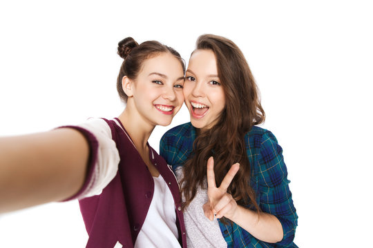 happy friends taking selfie and showing peace