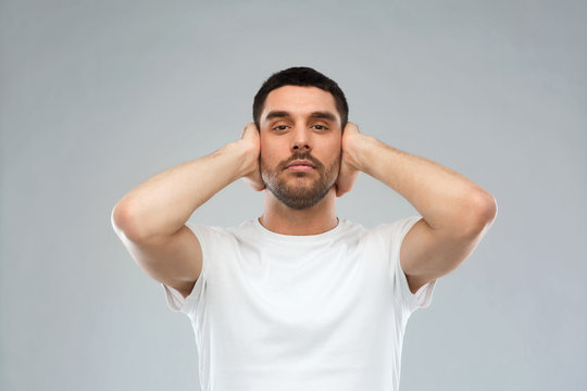 Latin Man Covering His Ears With Hand Palms