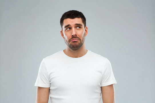 Unhappy Young Man Over Gray Background