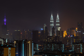 Fototapeta na wymiar KUALA LUMPUR, MALAYSIA - 31ST DECEMBER 2015; Kuala Lumpur, the capital of Malaysia. Its modern skyline is dominated by the 451m-tall KLCC, a pair of glass-and-steel-clad skyscrapers.