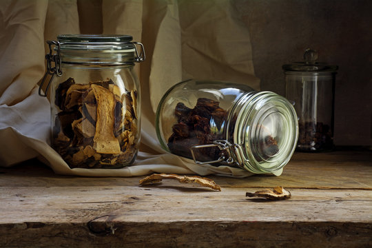 glass jars with dried food on an rustic wooden shelf, countrysid