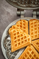 Home made heart shaped waffles served in a traditional cast iron waffle pan.