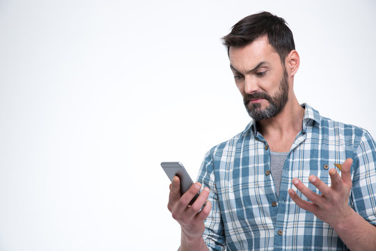 Angry man holding smartphone