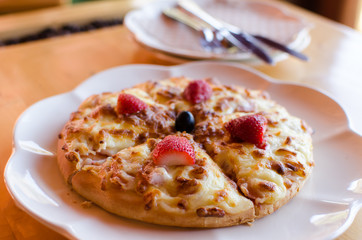 Delicious strawberry pizza on white plate