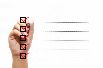 Businessman checking mark on checklist with marker over white