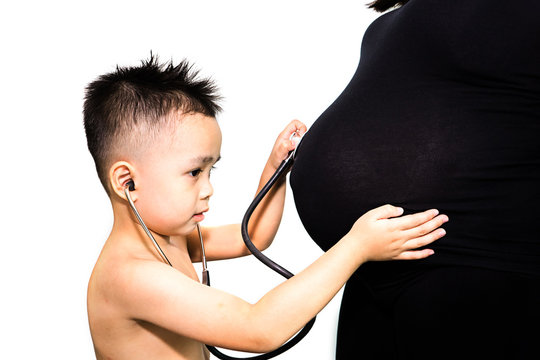 4 Year Old Boy Listening His Mother's Belly With A Stethoscope