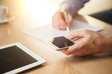 The male hand holding a phone 