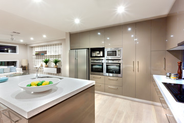 Modern kitchen area illuminated with lights at night