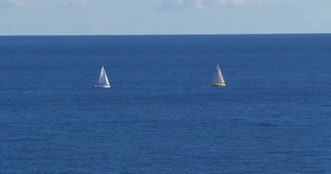 Sailing ship yachts with white sails in the open Mediterranean sea, Monaco.