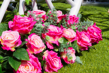 bouquet of pink rose on the green grass in sunshine