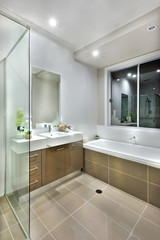 Fototapeta na wymiar modern bathroom with dark color floor tiles with lights on