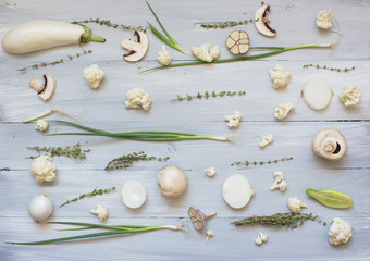 Collection of fresh white green toned vegetables raw on wood rustic background.