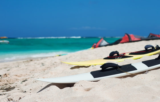 Surf board for kiting on the beach. Red kite and ocean on background. Selective focus. 