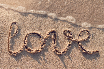 Word love on a tropical beach