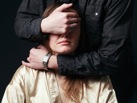 Man's  hands are choking woman