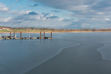 Obraz premium new build wooden brige on frozen lake Chiemsee