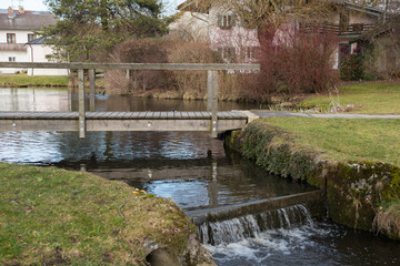 Fototapeta na wymiar pond with bridge and cascade in Bavaria