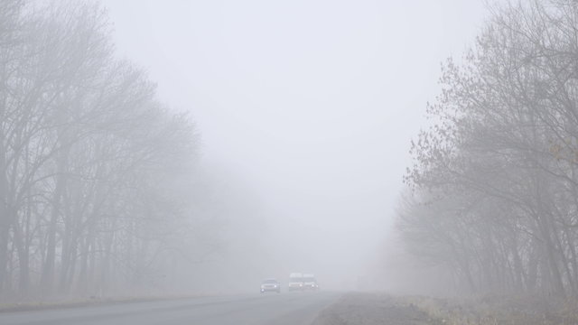 6 in 1 video! The slow-moving stream of cars on the road during heavy fog. Foggy weather, real time capture