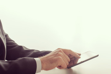 Obraz na płótnie Canvas Businessman using a tablet device