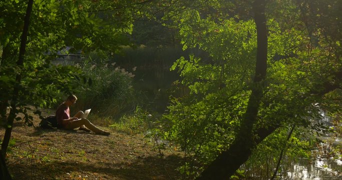 Man Looking at Laptop Screen Put it Away Freelance Programmer Designer Copywriter Accountant Pursed His Legs Sitting at River Bank Looking at Water
