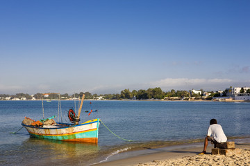Tunisia. Hammamet. Fishing boat and fisherman at the seashore