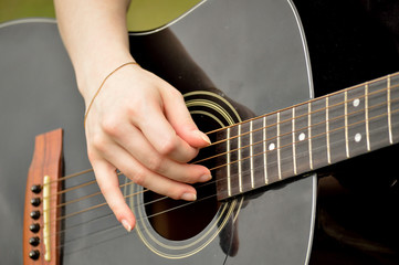 Woman playing black guitar