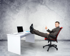Businessman sitting on chair with table laptop