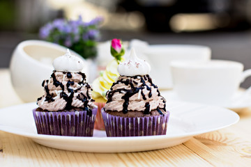 Chocolate Cupcake with chocolate frosting on the table