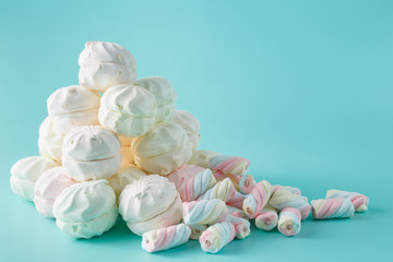 Colorful marshmallow heap on aquamarine background