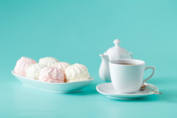 Pastel colored marshmallow and cup of tea