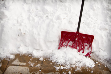 snow shovel in a snow bank - Powered by Adobe