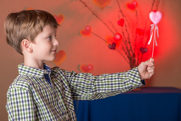 Boy gives a pink heart on Valentines Day.