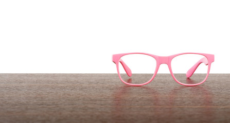 Pair of pink eyeglasses on table