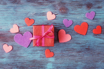 Red gift box on Valentines day over rustic background
