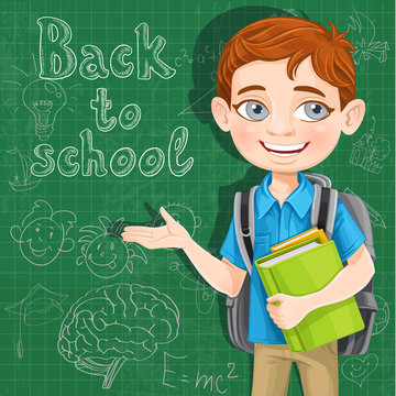 Back to school - cute boy with books at the blackboard