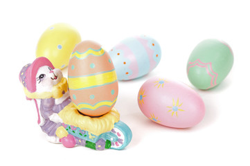 Fototapeta na wymiar Colorful Eggs with Easter Bunny Figurine on a White Background