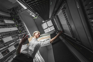 Young engineer businesswoman in server room