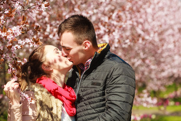 Couple in love walking in park at sunny spring day