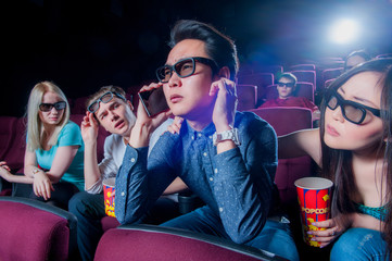 People in the cinema wearing 3d glasses