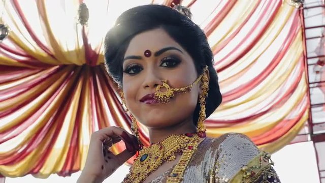 Shot of a Indian bride smiling and posing under a mandap