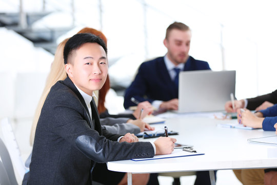 Young Asian businessman sitting at the business meeting in the office