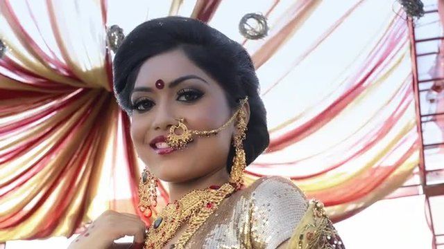 Shot of a Indian bride smiling and posing under a mandap