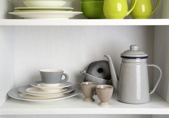 Tableware on shelves in the kitchen cupboard