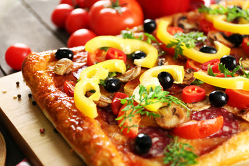 Rectangle delicious pizza and vegetables on the table, close-up
