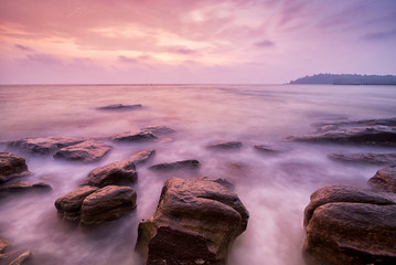 Sea waves lash impact rock on the beach