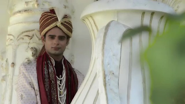 Shot of a Indian groom posing in traditional wedding dress