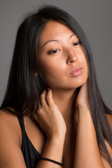Naklejka premium Beautiful Asian girl on a gray