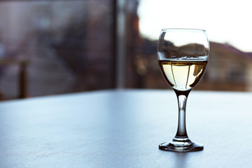 Glass of wine on light blurred background