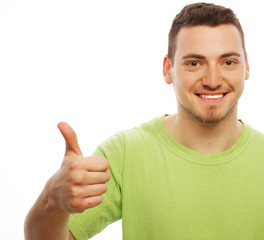 young man in green shirt  showing thumbs up. 